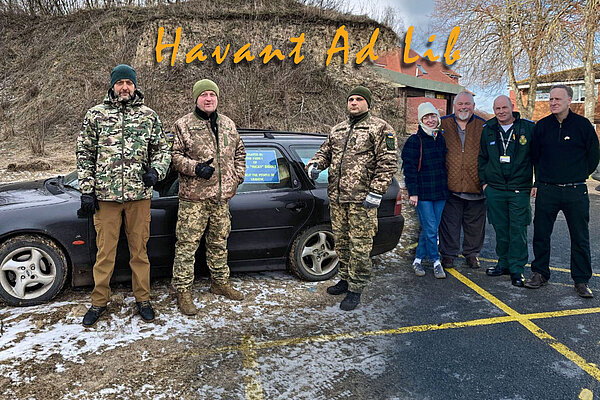 Some Ukrainian soldiers, with the car, and the team in the UK